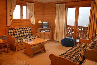 Living area of self catered rental apartment Bergerie F8, Les Allues with views towards Saulire from